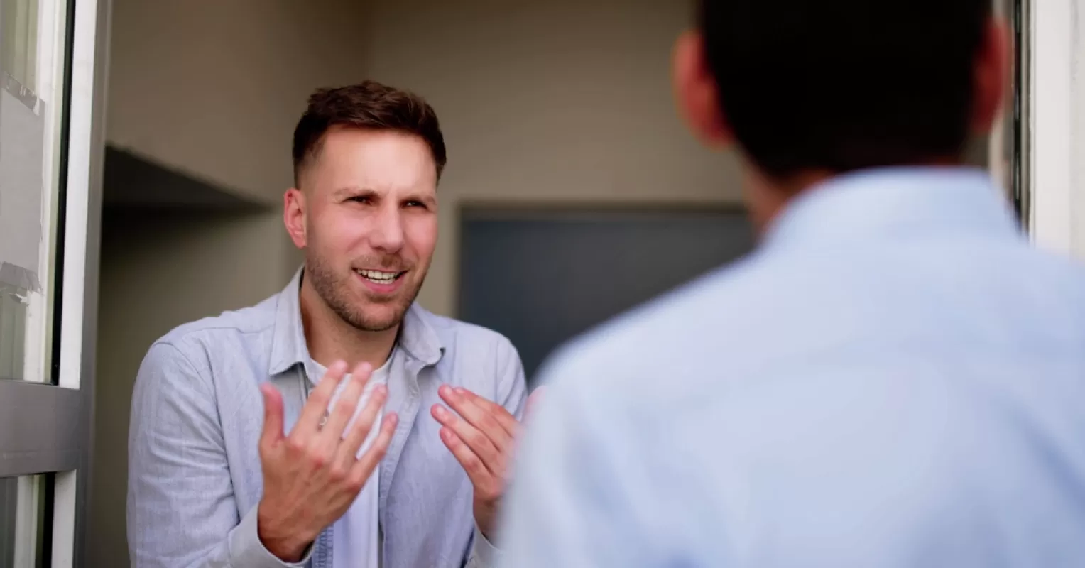 Person struggling to articulate feelings during a conversation, reflecting social dynamics of communication.