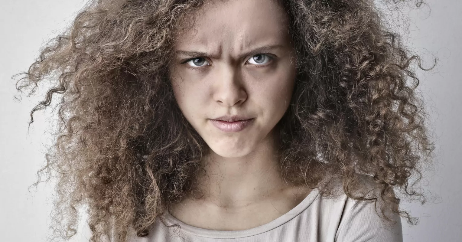 Person experiencing conflicting emotions of anger instead of love in a relationship setting