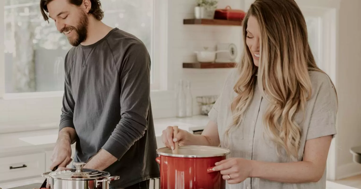 Individual managing household tasks alone, reflecting on emotional signals in relationships