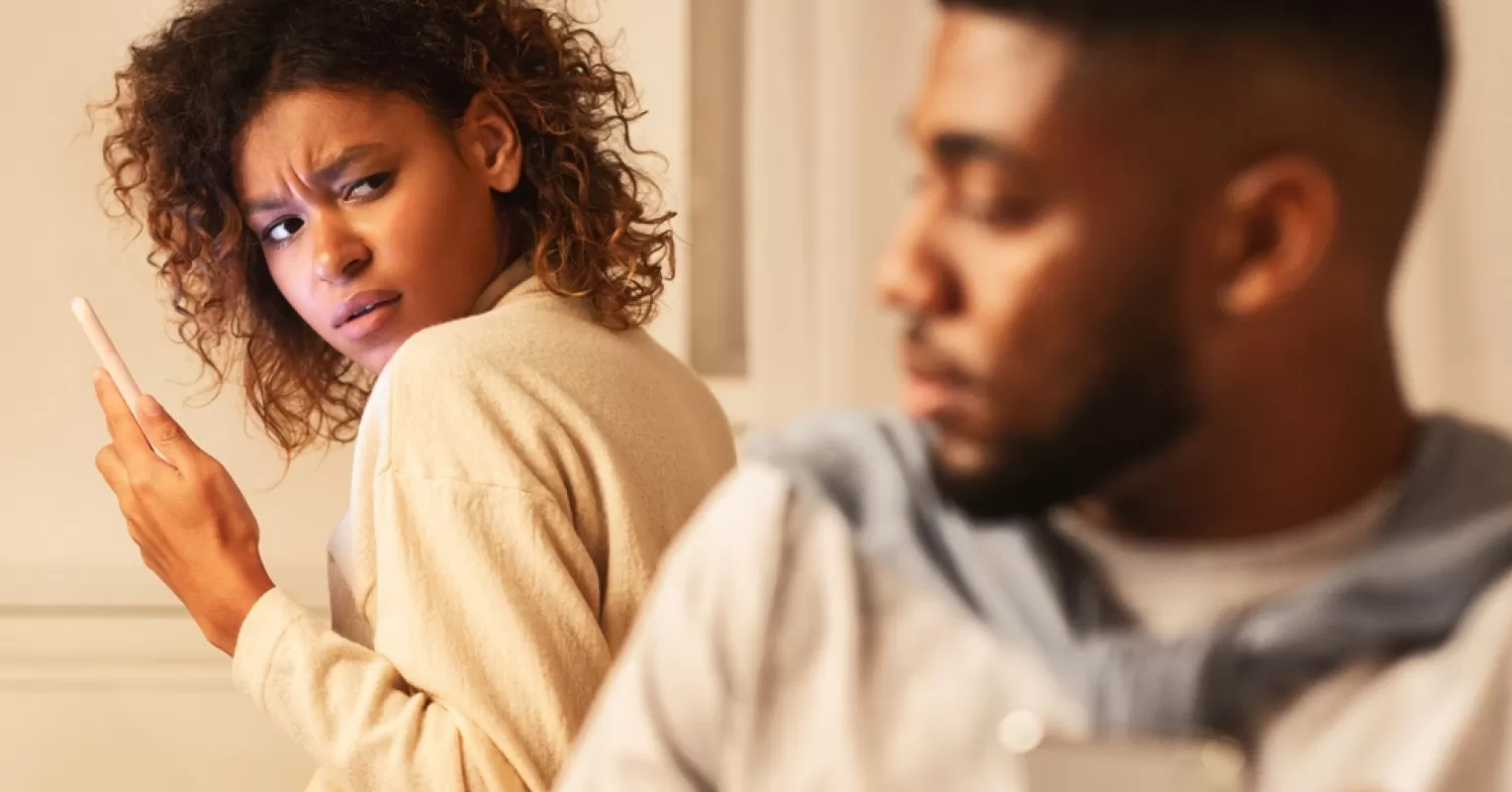 Couple engaged in open dialogue about digital boundaries after an affair.
