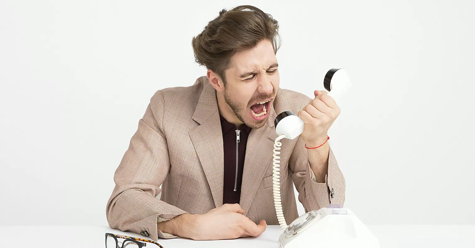 Person feeling frustrated after being cut off during a conversation with friends
