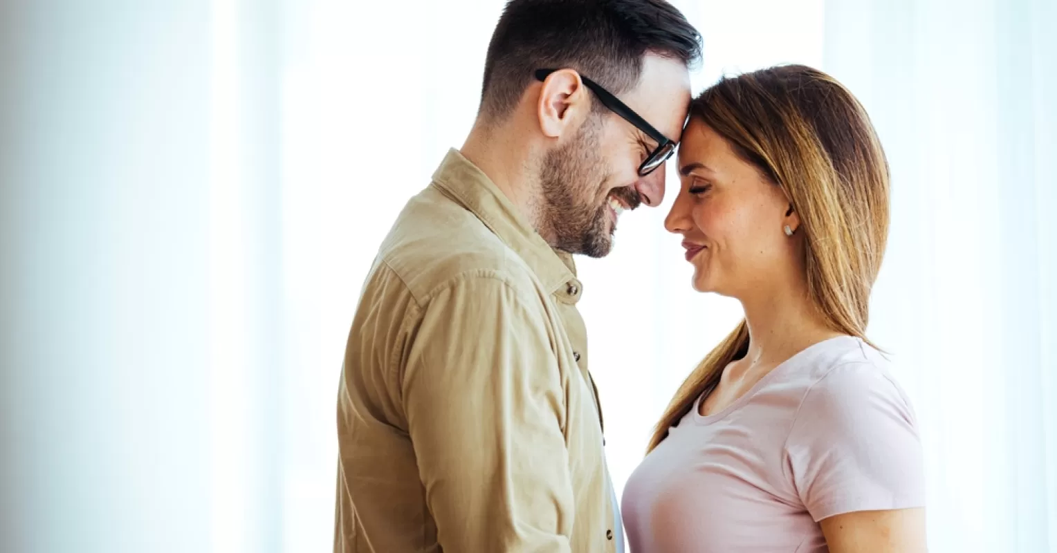 Couple sharing a tender moment, contemplating when to express love in their relationship