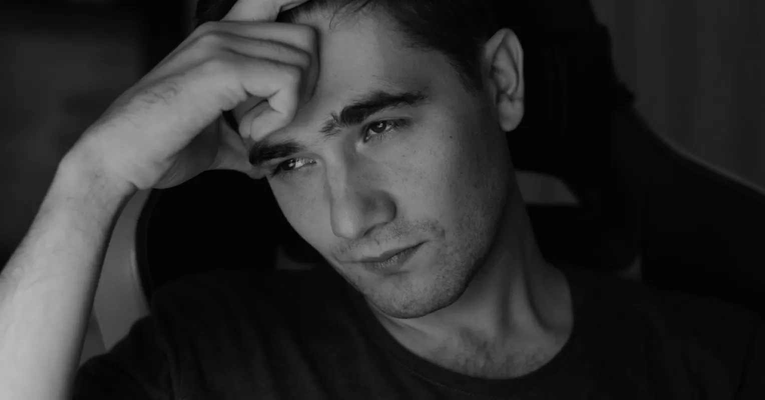 Individual pondering conflicting relationship signals, questioning partner's commitment