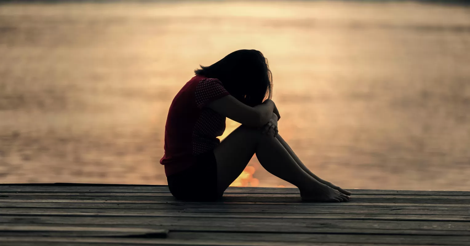 Individual feeling distant from friends during the grieving process, showcasing emotional isolation