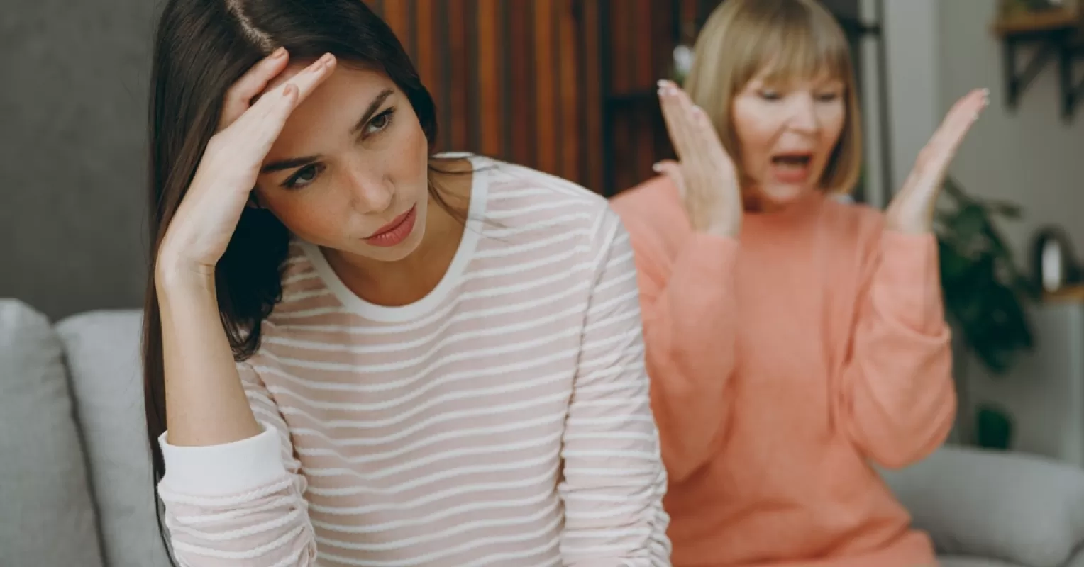Person feeling conflicted while confronting emotionally immature parents about hurtful behavior