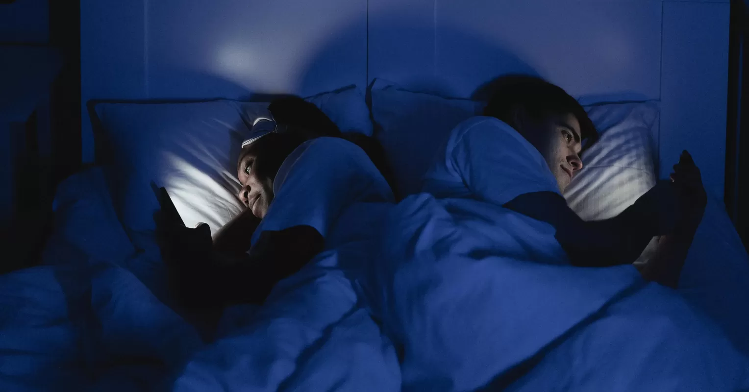 Person feeling neglected while partner focuses on phone, highlighting relationship signals.
