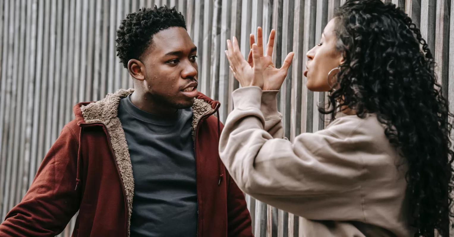 Couple experiencing emotional overwhelm during a heated argument in their living room