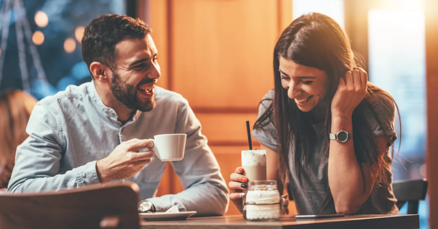 Couple sitting together, conversations turning serious, exploring relationship signals in communication.