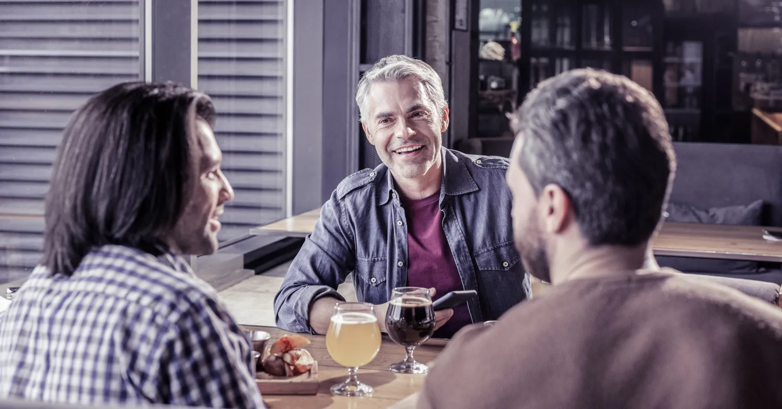 Individual feeling uneasy while observing their partner interact with others in a social setting