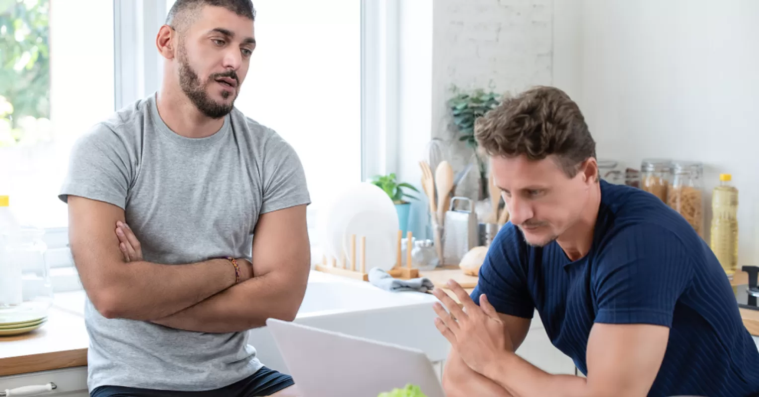 Couple sitting together, one partner looks frustrated while speaking, feeling unheard.