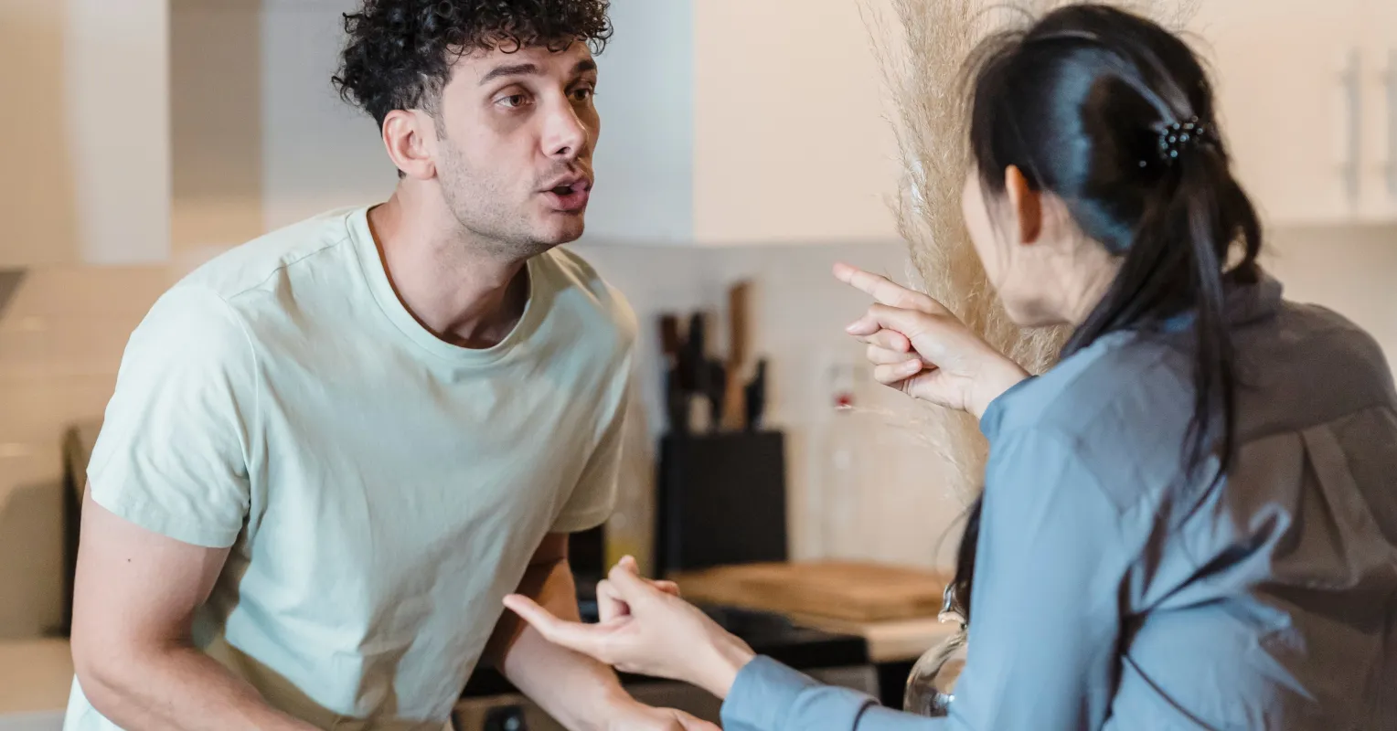 Person feeling defensive during a disagreement, reflecting on relationship signals