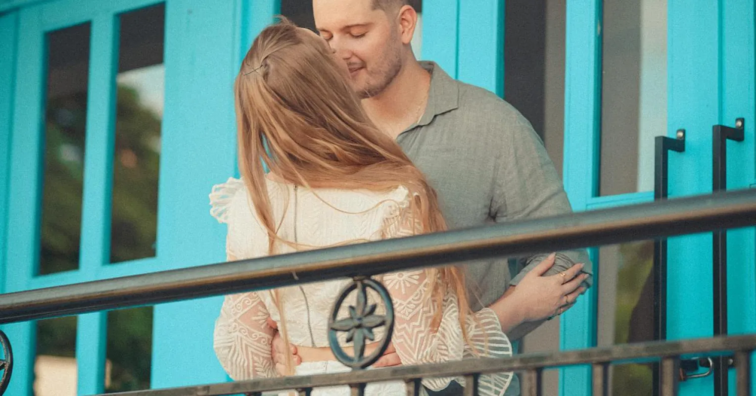 Couple sitting apart, showing discomfort with physical affection due to emotional barriers.