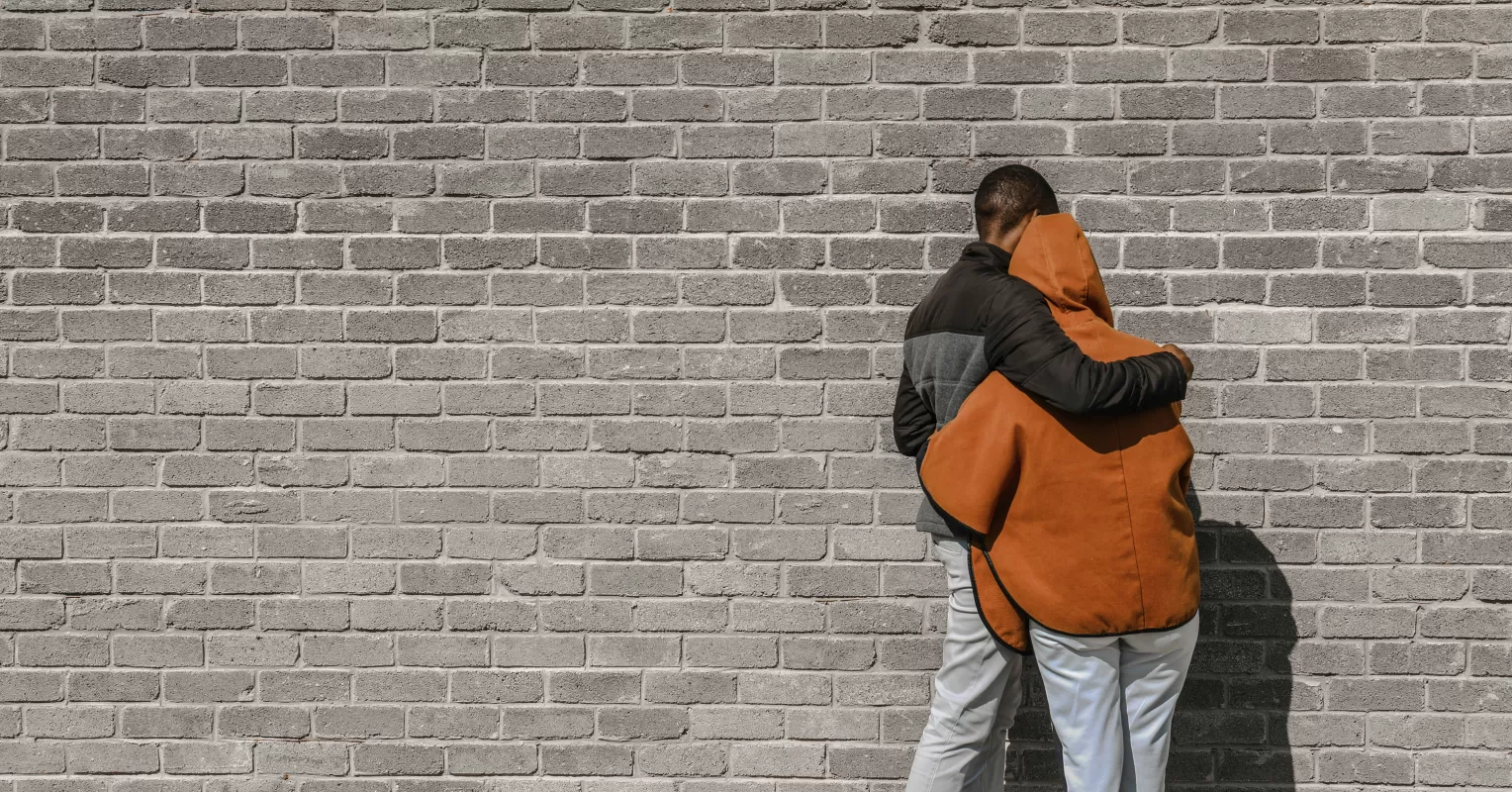 Couple facing away from each other, reflecting on challenges of forgiveness in relationships