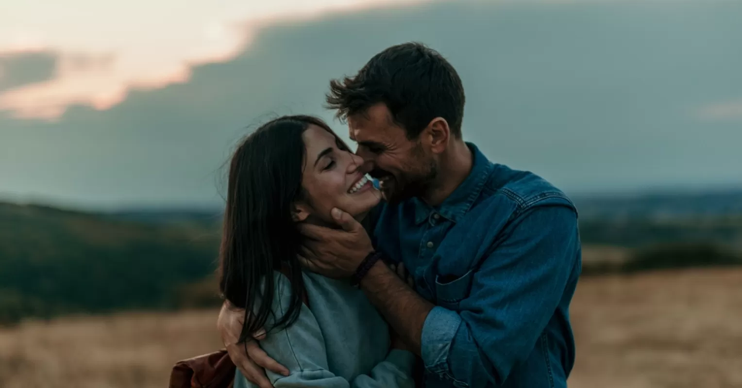 Couple sitting apart, reflecting on emotional connection in their romantic relationship