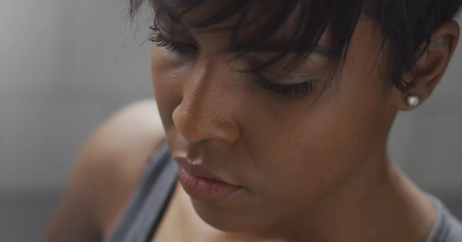 Person contemplating a recent message from an ex after a long period of silence