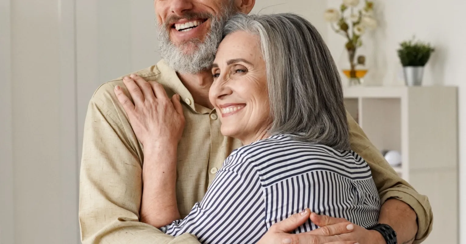 Couple sitting silently while one partner seems hesitant to engage in deep conversation