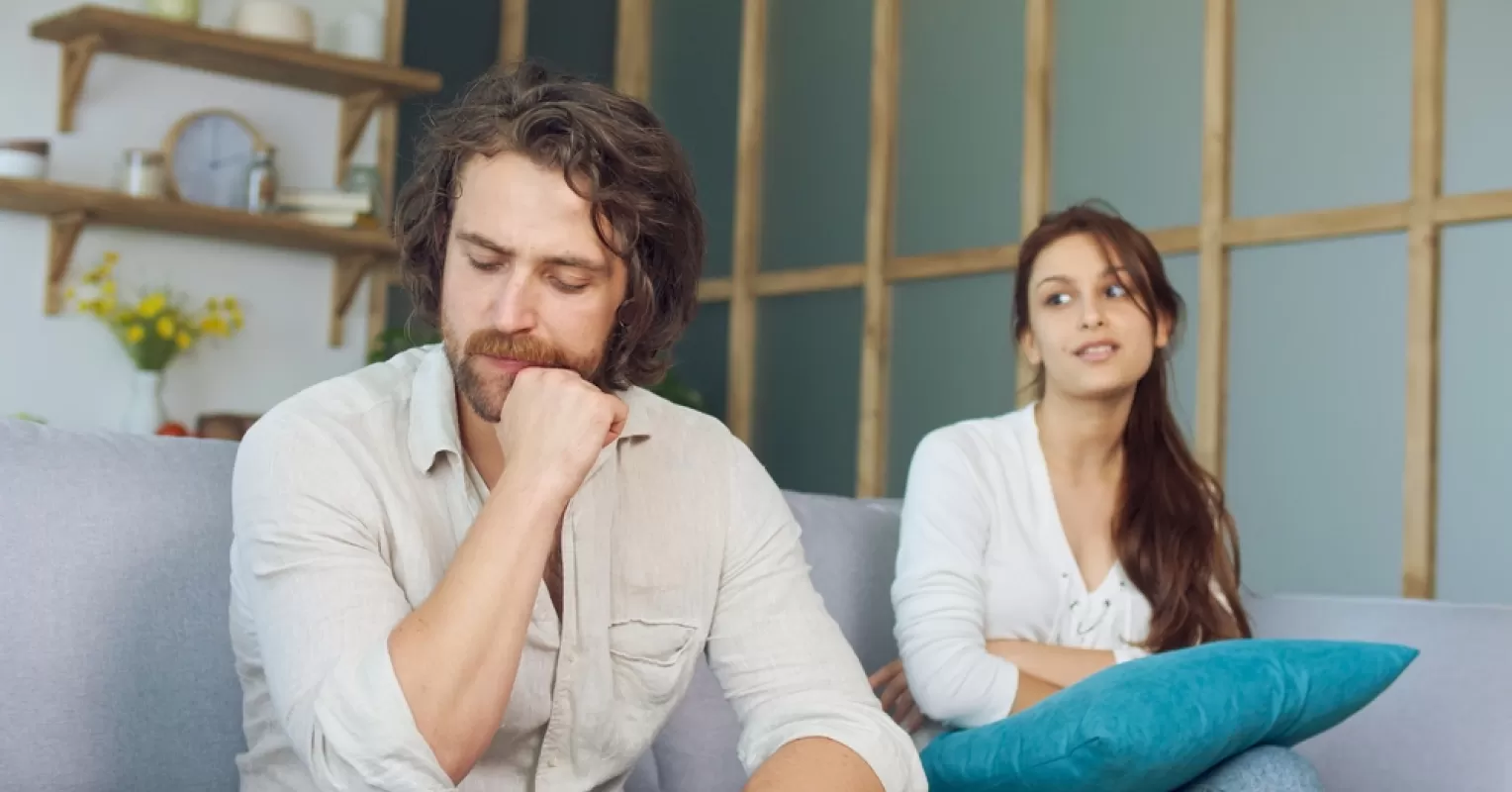 Person experiencing pain after harsh words exchanged during an argument in a relationship