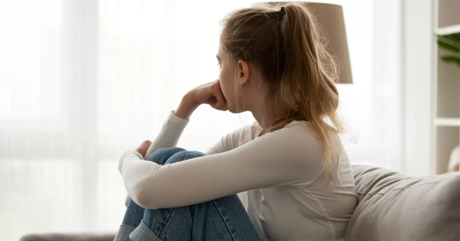 Person reflecting on uncertainty in a relationship connected to partner seem distant after we argue