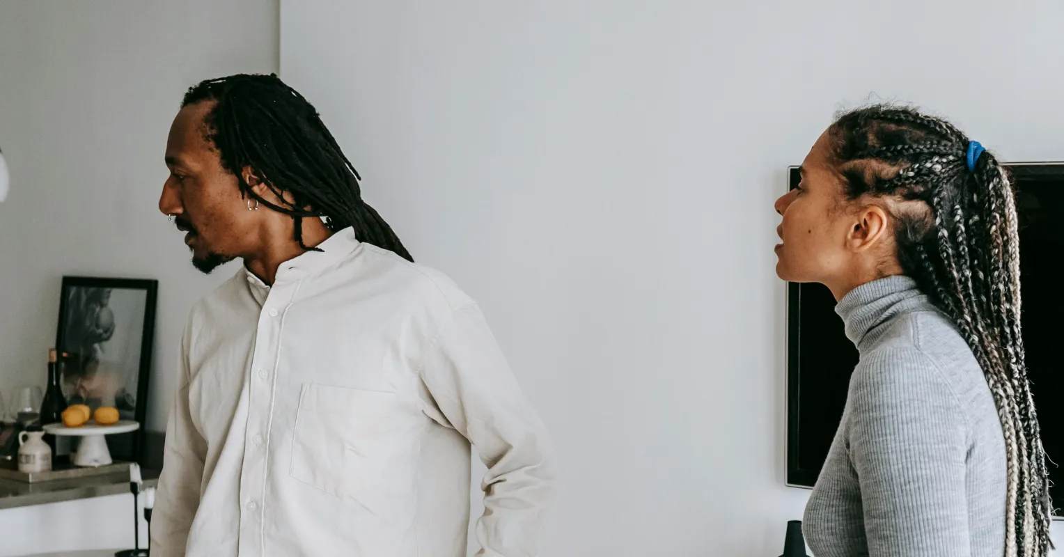 Couple appearing frustrated while discussing past conflicts during an argument