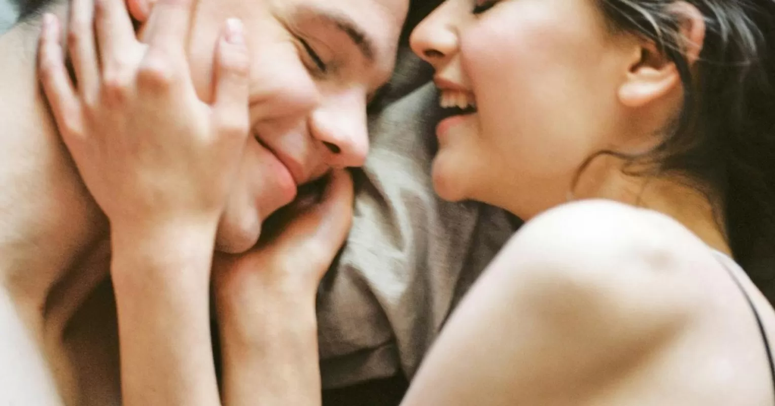 Couple sitting apart, reflecting on feelings of disconnection after watching porn