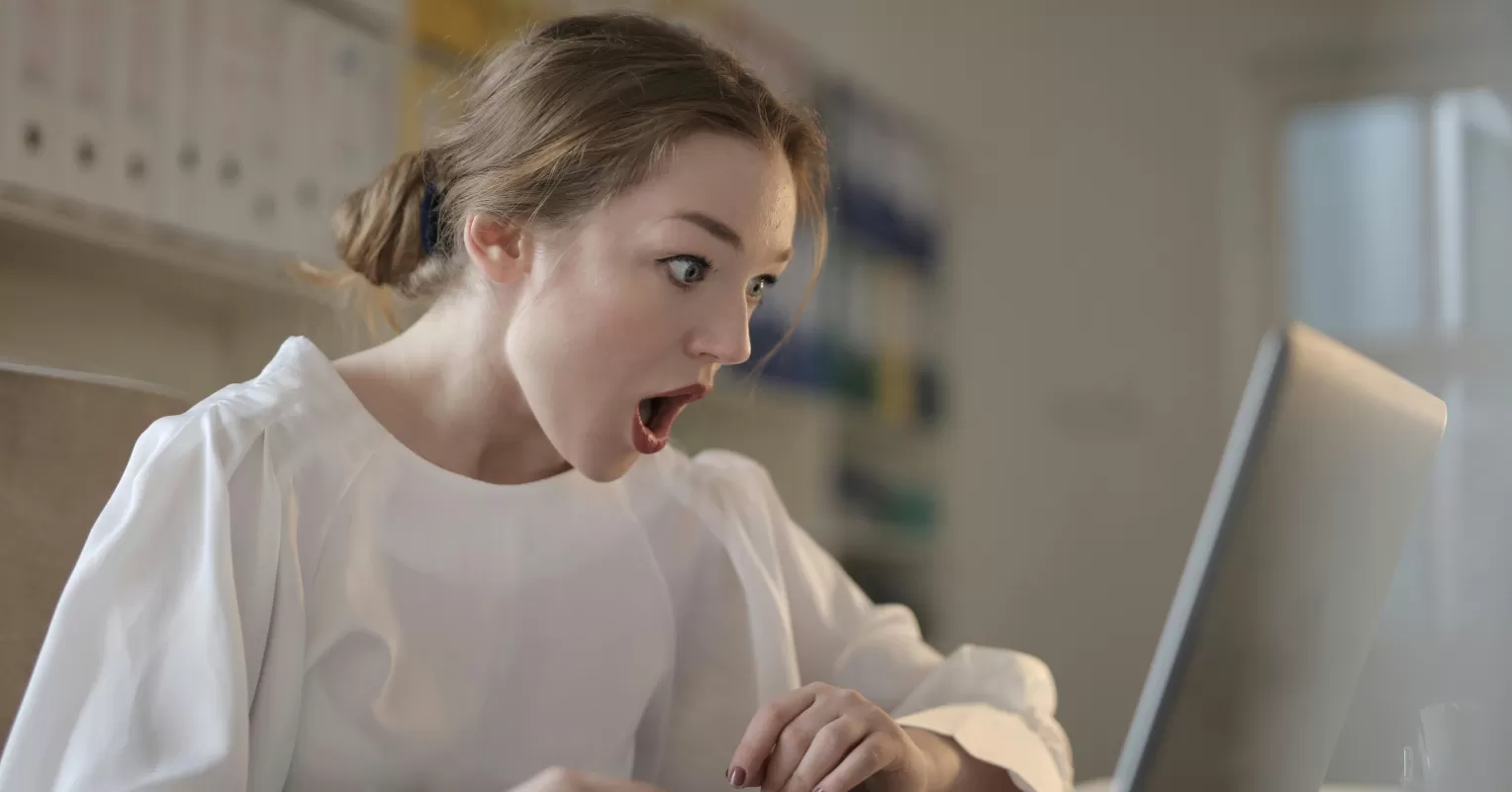 Individual scrolling through social media, feeling inadequate while comparing themselves to peers