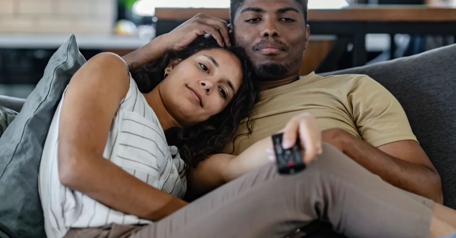 Couple looking pensive while sitting together, reflecting on long-term relationship excitement.