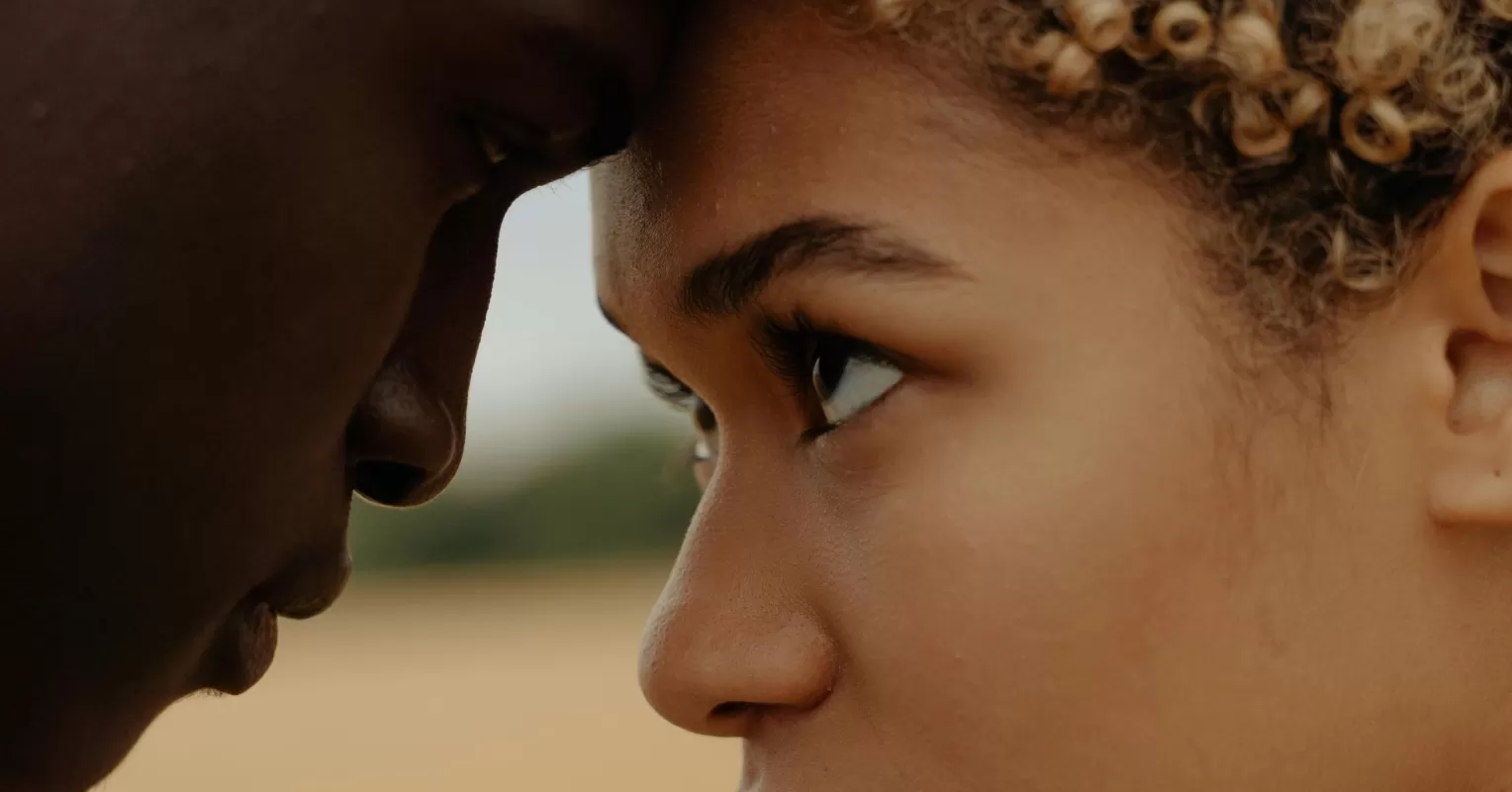 Couple sitting apart, reflecting on feelings of emotional disconnection in their relationship