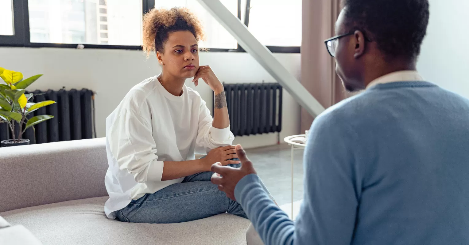 Individual experiencing emotional stress while contemplating overwhelmed feelings in close relationships