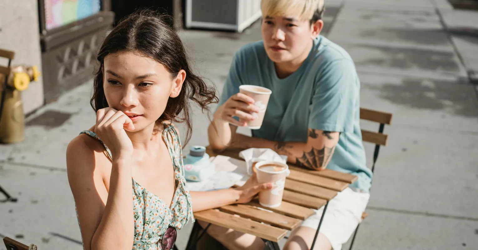 A person deep in thought, grappling with emotions of idealizing a late spouse while dating.