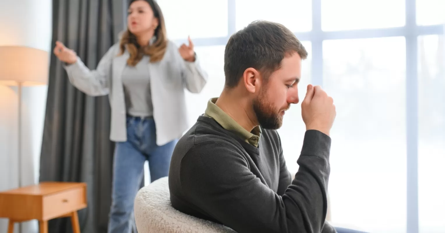 Individual observing warning signs of manipulative behavior in a partner during a tense conversation