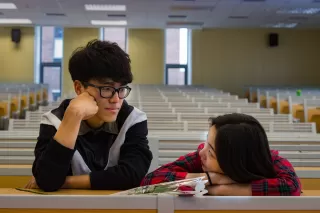 Teenagers engaging with social media, reflecting on its effects on their emotional well-being