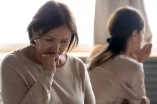 Couple engaged in deep conversation, practicing how to listen without getting defensive