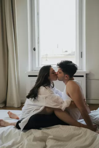 A couple sharing a light moment, reflecting on the pros and cons of friends with benefits