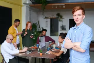 A person observing tense interactions among coworkers displaying passive-aggressive behavior.