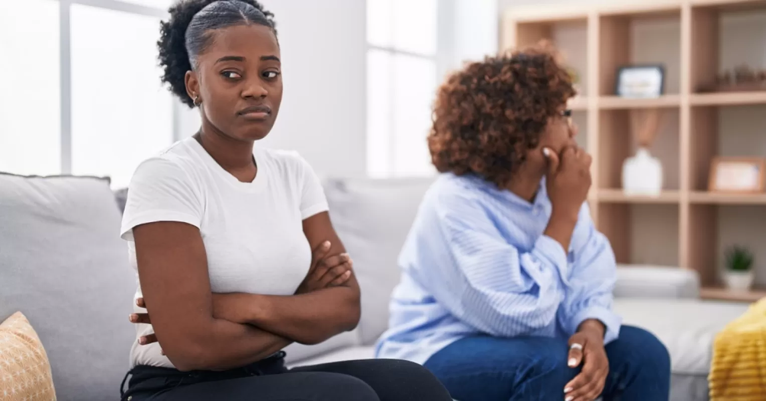 Young adult contemplating feelings of resentment towards parents during a quiet moment