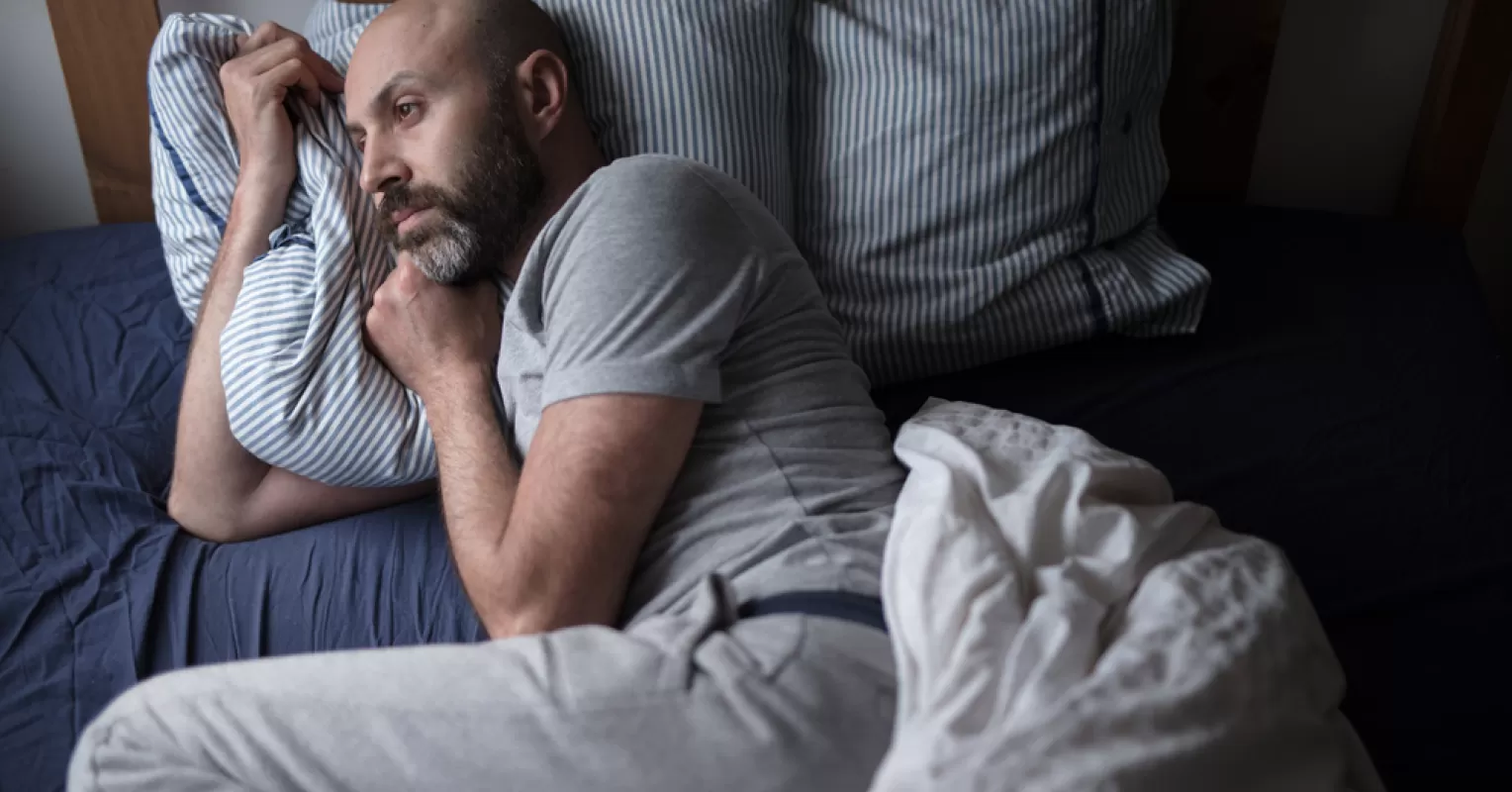 Individual contemplating feelings of inadequacy while observing a couple's interaction