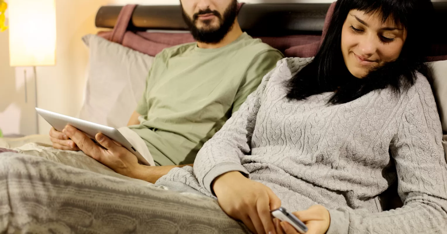 Couple discussing emotional distance and signs of infidelity in a cozy setting