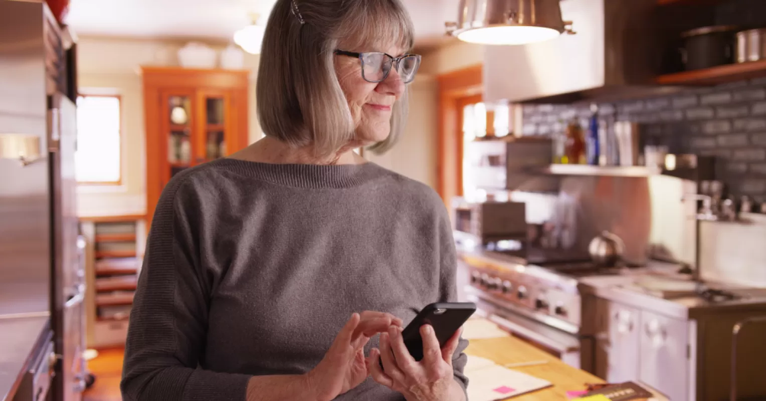 Individual contemplating feelings of isolation while using technology in a social setting