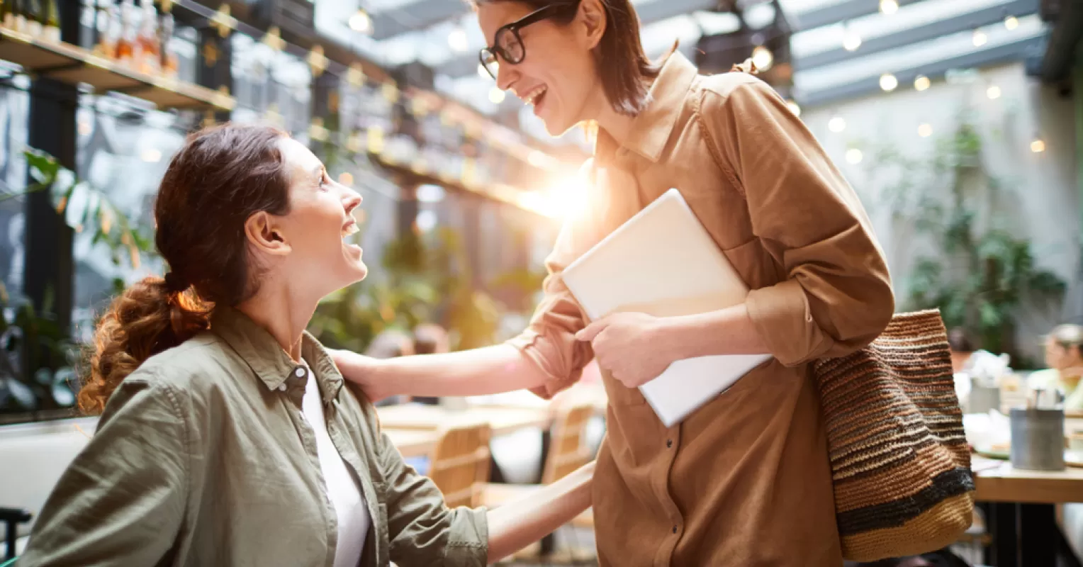 Two friends sharing a heartfelt conversation to reconnect after a falling out