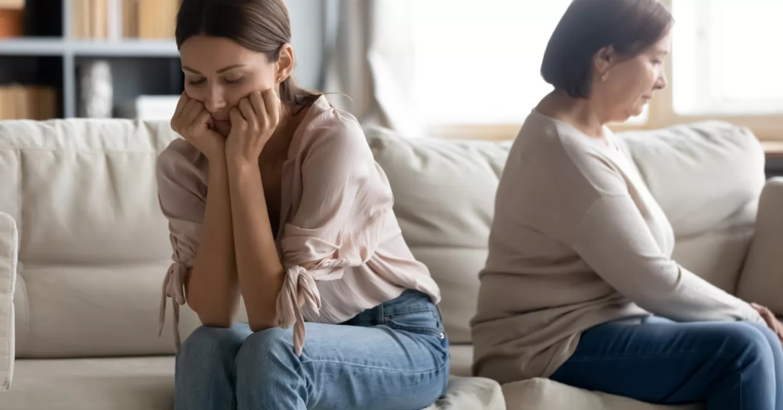 Adult child discussing personal boundaries with controlling parents in a calm setting
