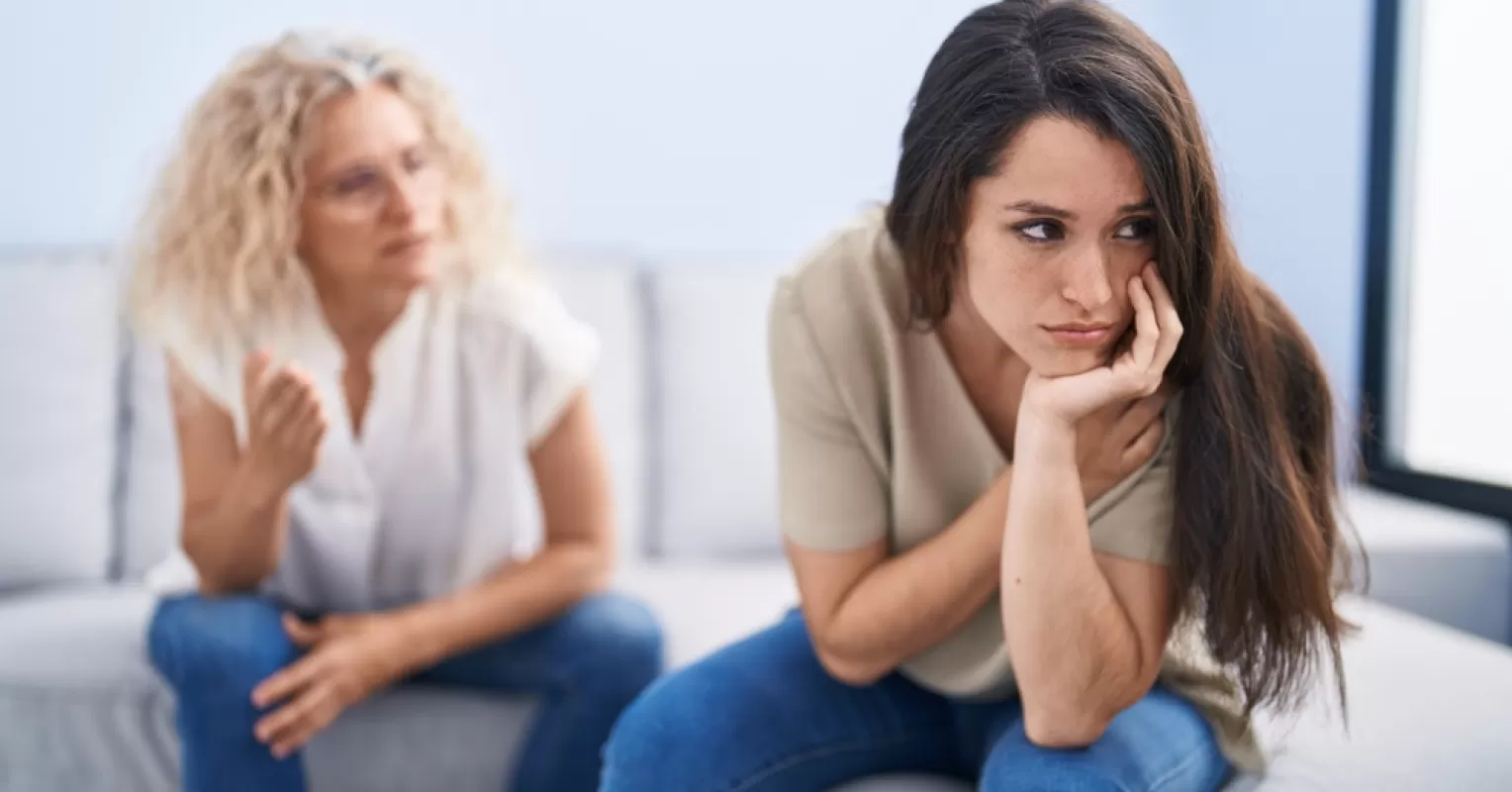 Adult child discussing personal boundaries with parents in a warm living room setting