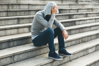 Individual contemplating self-sabotage while reflecting on personal happiness and emotional patterns