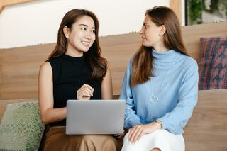 Two friends engaged in deep conversation, interpreting unspoken messages and reading between the lines.
