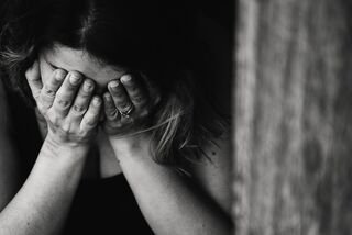 Two siblings standing apart, reflecting on the emotional signals of estrangement