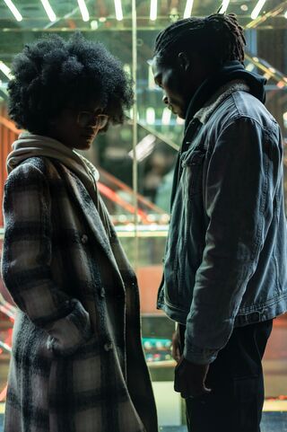 Two siblings sitting apart, reflecting on their estrangement and emotional distance