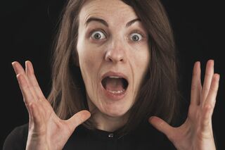 Individual displaying defensive behavior, indicating signs of projecting insecurities onto others