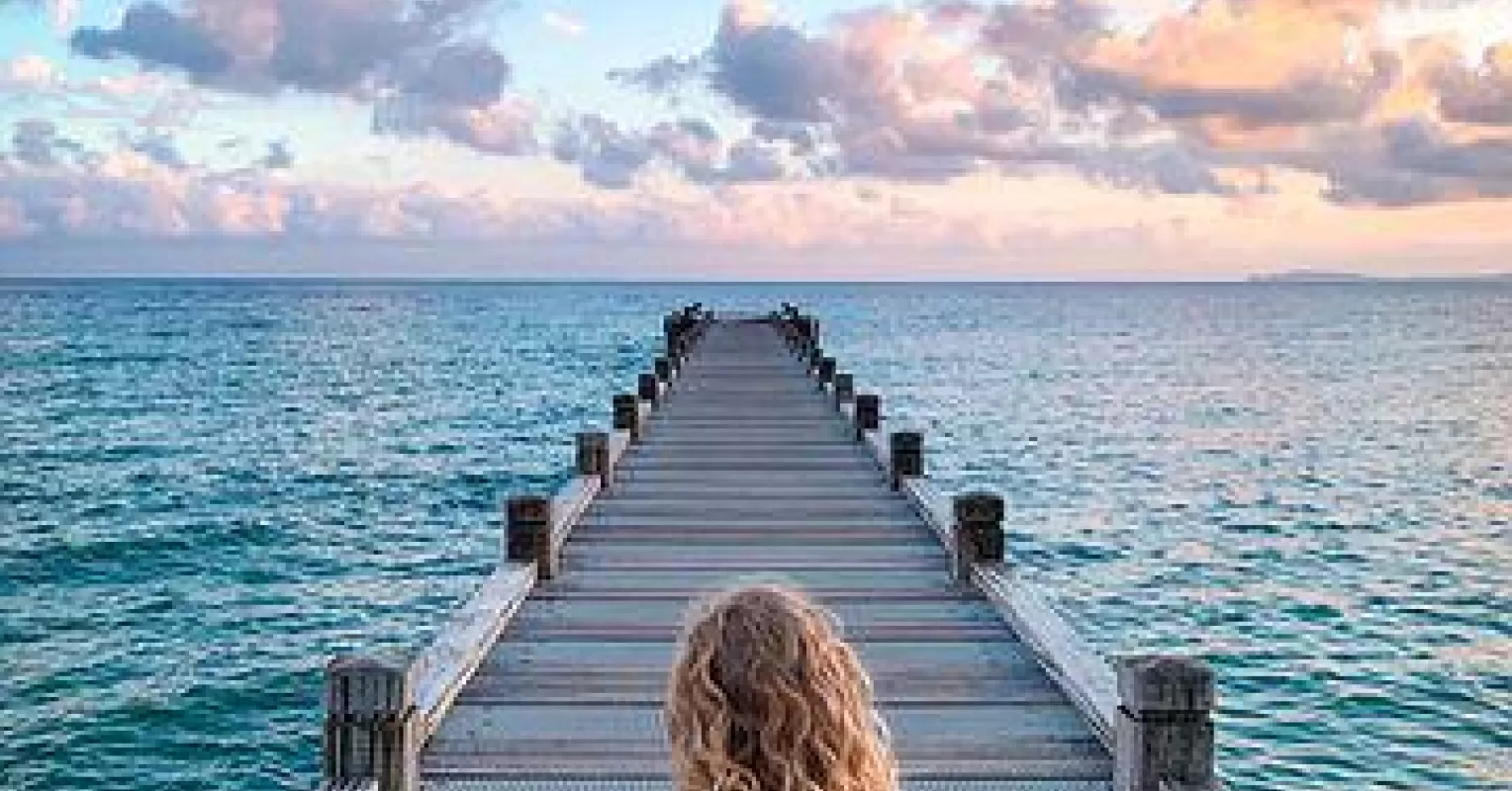 Couple sitting apart, reflecting on what are the benefits of taking a break in their relationship