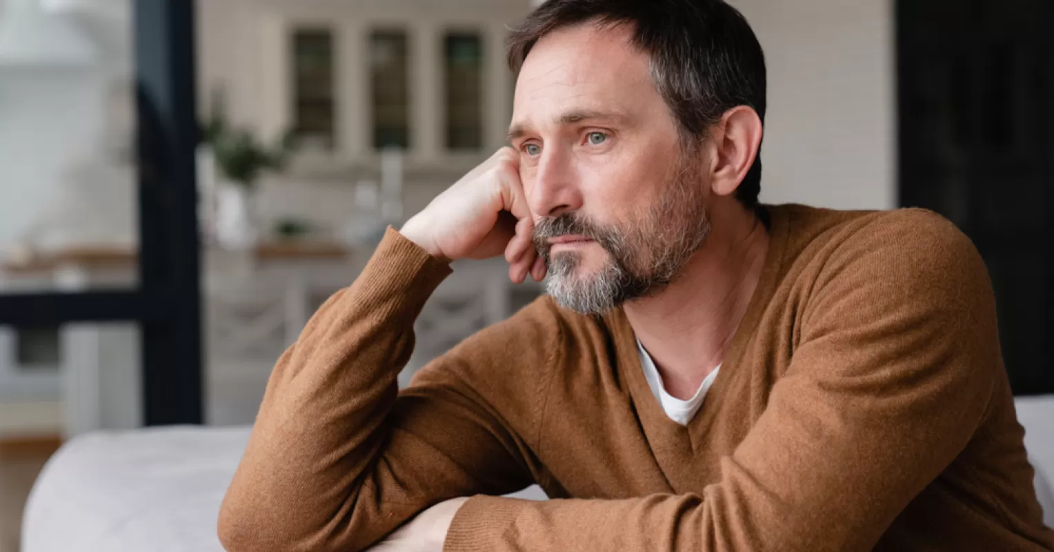 Two siblings standing apart, reflecting on the causes of sibling estrangement