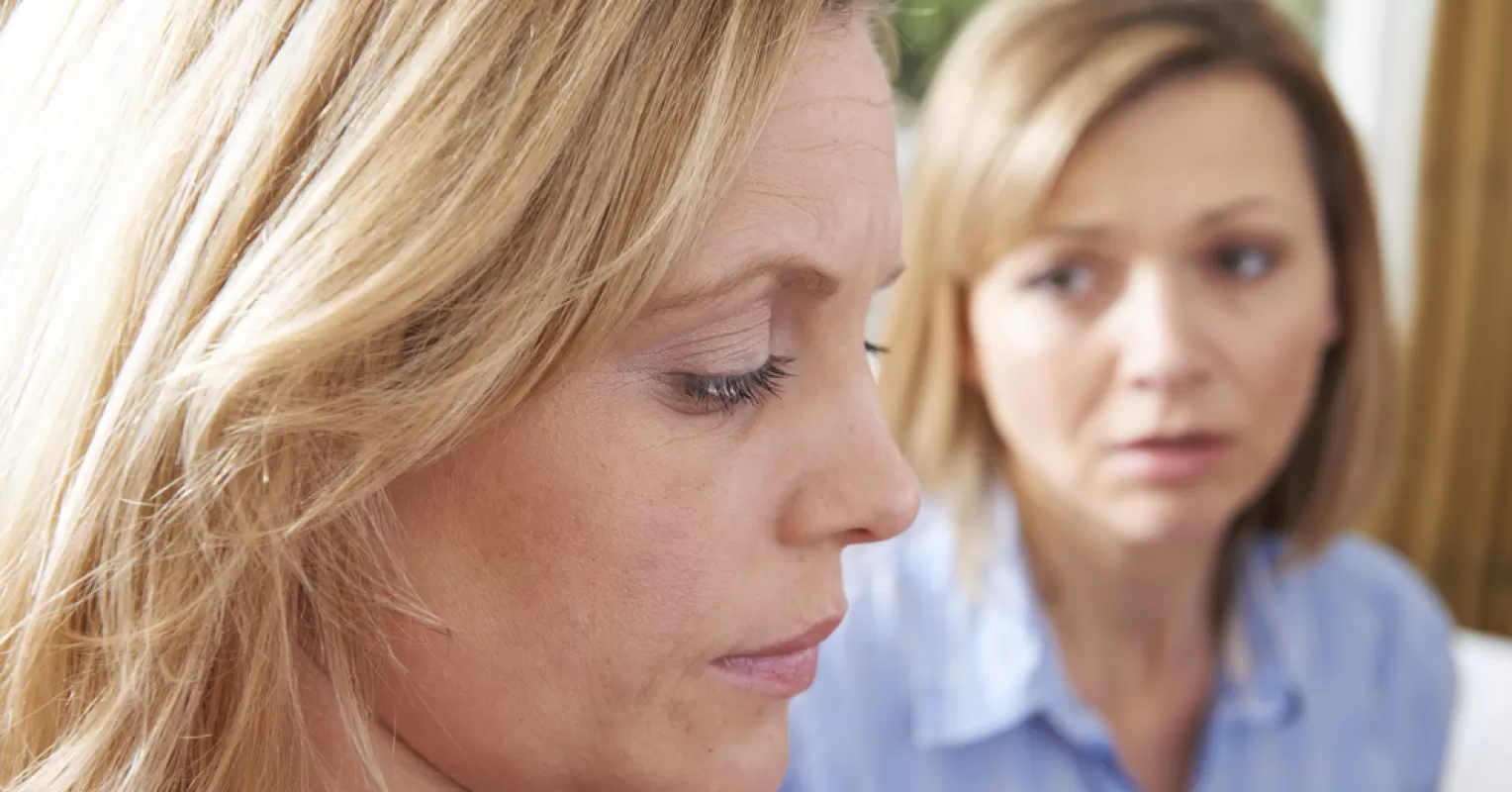 Two adult siblings experiencing tension, reflecting on what causes sibling rivalry in adulthood