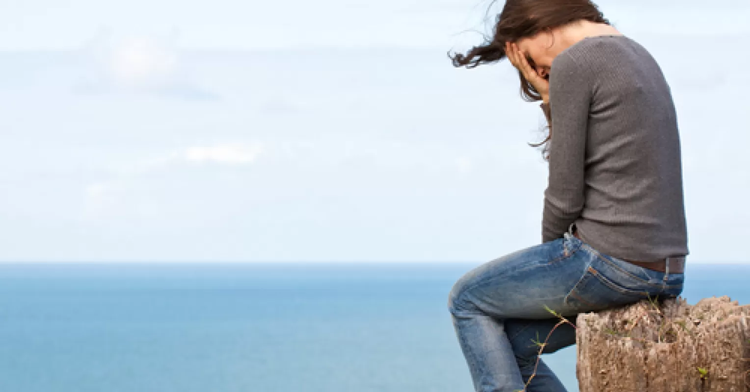 Individual experiencing disenfranchised grief while reflecting on unacknowledged loss in relationships